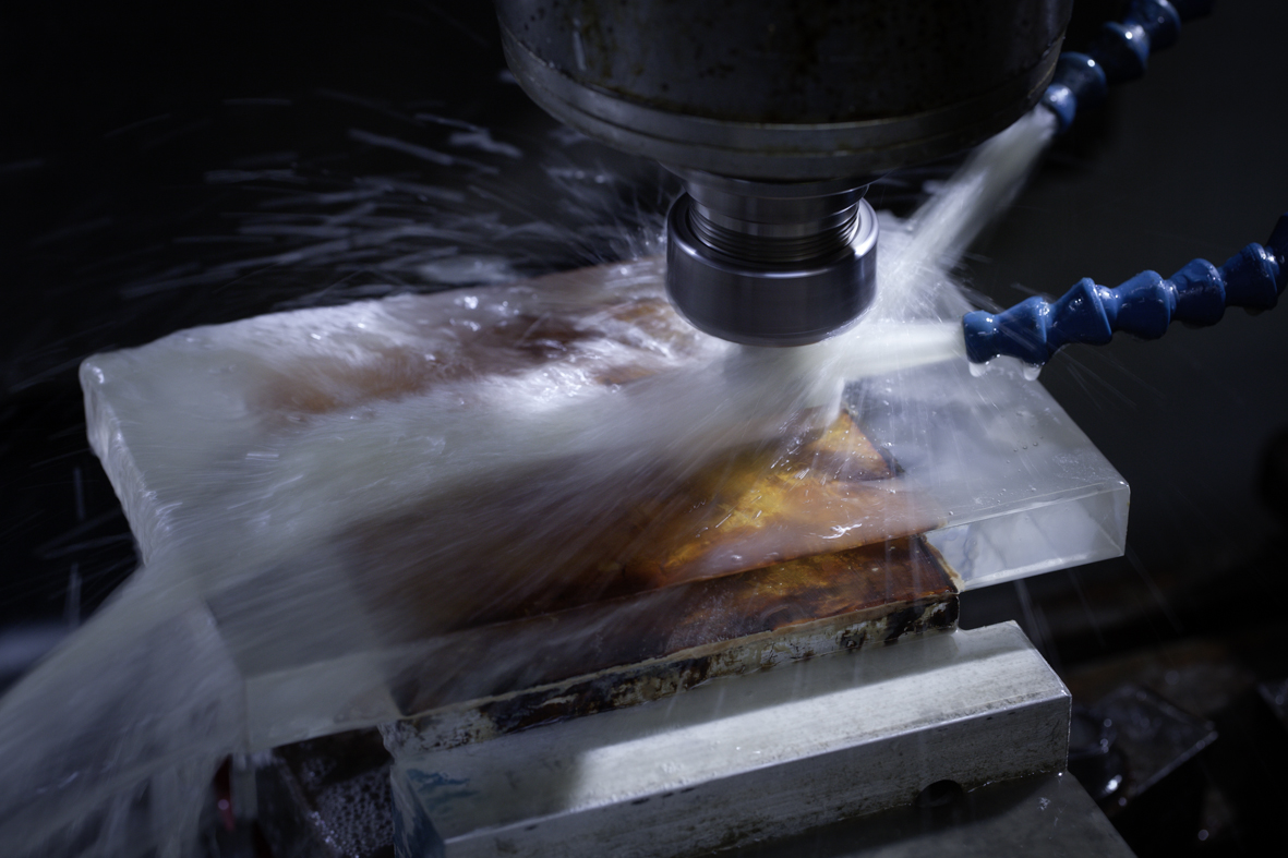 PG&O's fabrication services include machining glass, done here on a Haas CNC machine.