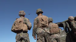 Warfighters Watching Drone Using Near Earth Autonomy’s System Fly In To Deliver Cargo