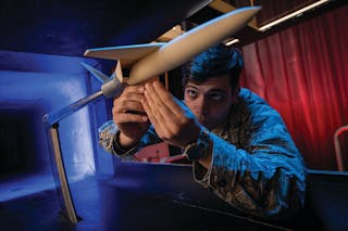 U.S. Air Force Academy Cadet Michael Higgins mounts a 3D printed model in a subsonic wind tunnel for testing at the academy in Colorado Springs, Colo.