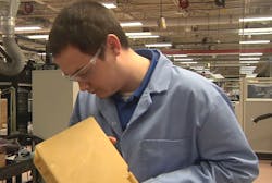 Technician at a Northrop Grumman Corp. facility in Charlottesville, Virginia, inspecting a 3D printed manifold for one of their navigation systems. Technician at a Northrop Grumman Corp. facility in Charlottesville, Virginia, inspecting a 3D printed manifold for one of their navigation systems.