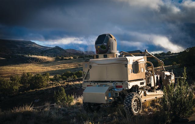 The Raytheon High Energy Laser Weapon System (HELWS) is shown mounted on a Polaris MRZR all-terrain vehicle. The laser uses pure energy to detect, identify, and take down enemy drones.