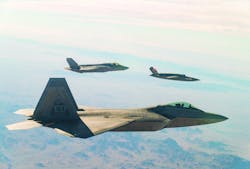 A U.S. Air Force F-22 Raptor and F-35A Lightning II manned combat aircraft fly in formation with the XQ-58A Valkyrie low-cost unmanned aerial vehicle over the U.S. Army Yuma Proving Ground testing range, Ariz.