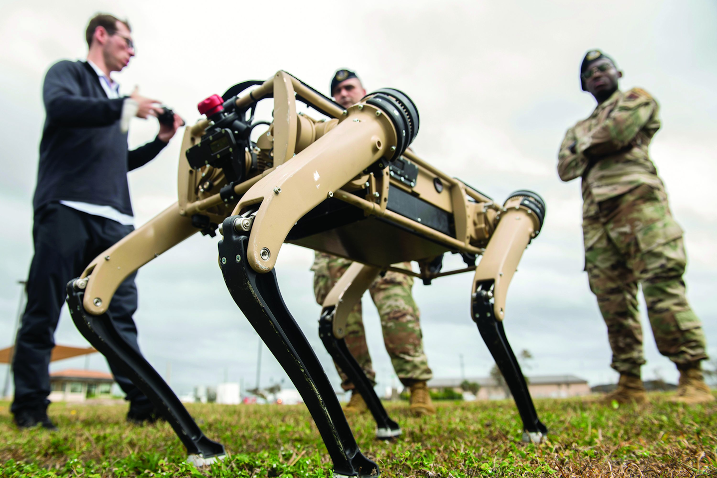 Airmen watch a test of an unmanned ground vehicle at Tyndall Air Force Base, Fla., as part of a plan to use the “computerized canines” to aid in reconnaissance and enhanced security patrolling operations across the base.