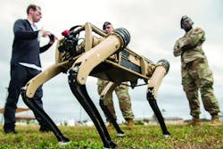 Airmen watch a test of an unmanned ground vehicle at Tyndall Air Force Base, Fla., as part of a plan to use the &ldquo;computerized canines&rdquo; to aid in reconnaissance and enhanced security patrolling operations across the base.