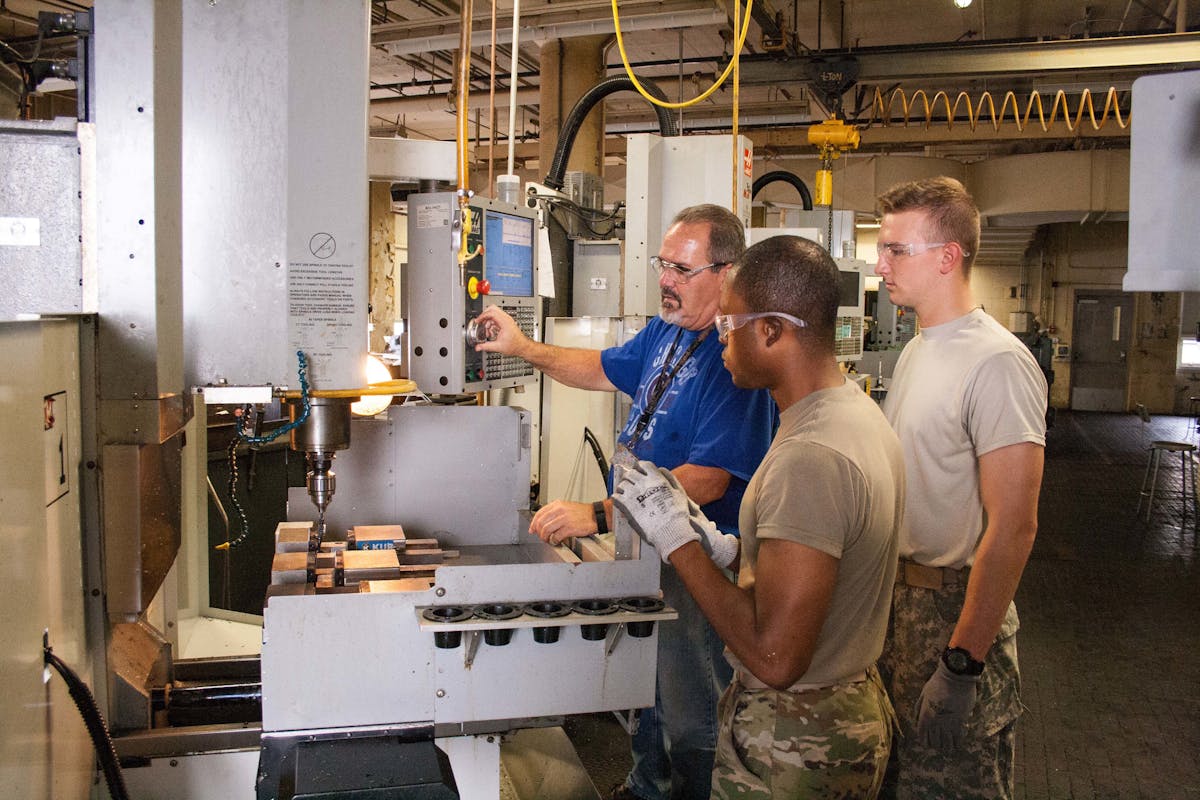 Army personnel observe additive manufacturing at the U.S. military Joint Manufacturing and Technology Center at Rock Island Arsenal, Ill.