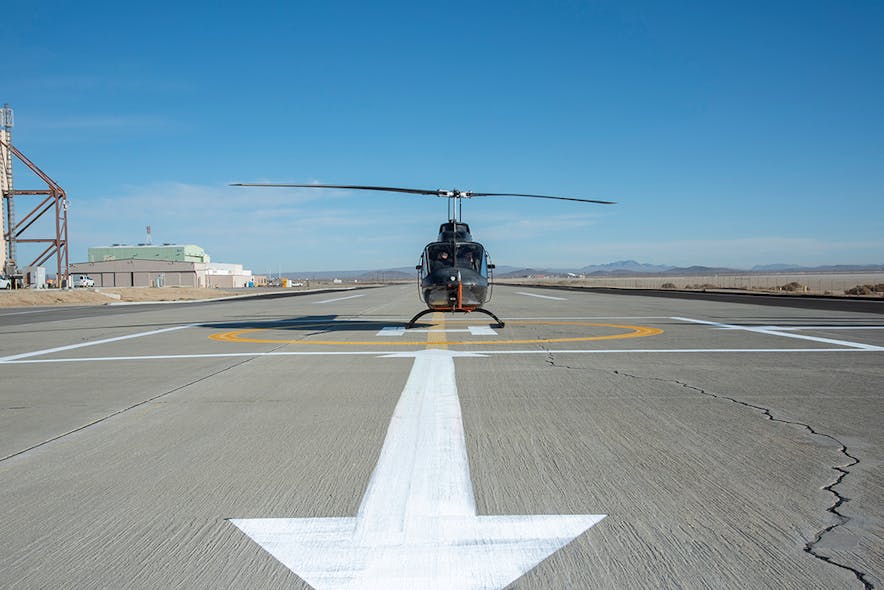 A Bell OH-58C Kiowa helicopter provided by Flight Research Inc. of Mojave, Calif., sits on a helipad at NASA&rsquo;s Armstrong Flight Research Center in California.