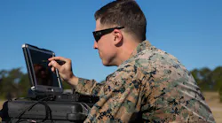 Sgt. Kyle Phillips configures computer equipment to ensure communications and controls connected to a Raven small unmanned aircraft system are working properly at Marine Corps Base Camp Lejeune, N.C.