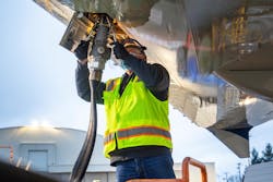 Aviation maintenance technician loads sustainable aviation fuel into the 2021 Boeing ecoDemonstrator.