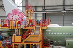 Airbus employees paint the tail emblem on China Airlines&apos; A321neo prior to delivery.
