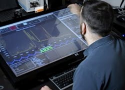 A materials researcher examines experimental data on the Autonomous Research System AI planner, developed by the U.S. Air Force Research Laboratory.