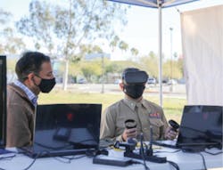 Rotors President Neil Malhotra instructs Lt. Col. Brandon Newell of Marine Corps Installations West on drone flight during a 5G Demo Day test event at Norco College in 2021.