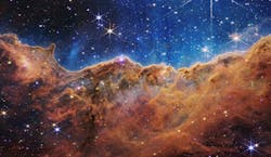 This landscape of “mountains” and “valleys” speckled with glittering stars is actually the edge of a nearby, young, star-forming region called NGC 3324 in the Carina Nebula. Captured in infrared light by NASA’s new James Webb Space Telescope, this image reveals for the first time previously invisible areas of star birth. This landscape of “mountains” and “valleys” speckled with glittering stars is actually the edge of a nearby, young, star-forming region called NGC 3324 in the Carina Nebula. Captured in infrared light by NASA’s new James Webb Space Telescope, this image reveals for the first time previously invisible areas of star birth.