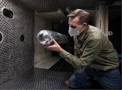 Researchers look at a directed-energy (DE) system turret in the four-foot transonic wind tunnel at Arnold Air Force Base, Tenn., last March.