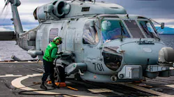 Aviation Electronics Technician 2nd Class Erica Evans, from Stafford, Va., conducts maintenance on an MH-60R Sea Hawk helicopter on the USS Chancellorsville in the Philippine Sea. Navy photo.