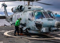 Aviation Electronics Technician 2nd Class Erica Evans, from Stafford, Va., conducts maintenance on an MH-60R Sea Hawk helicopter on the USS Chancellorsville in the Philippine Sea. Navy photo.