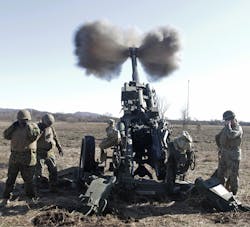 A Marine artillery gun crew fires an M777 howitzer during a training exercise at Quanah Range on Fort Sill, Okla. The Precision Guidance Kit (PGK) “smart” fuzes were installed on 155-millimeter shells fired from the howitzers. U.S. Army photo. A Marine artillery gun crew fires an M777 howitzer during a training exercise at Quanah Range on Fort Sill, Okla. The Precision Guidance Kit (PGK) “smart” fuzes were installed on 155-millimeter shells fired from the howitzers. U.S. Army photo.