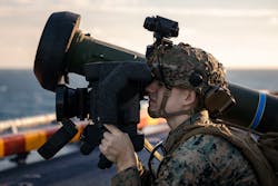 A Marine Corps anti-tank missileman aims a Javelin shoulder-fired anti-tank missile aboard the Wasp-class amphibious assault ship USS Kearsarge (LHD 3).