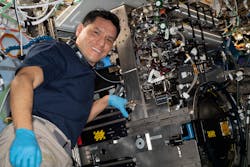Astronaut Frank Rubio works on components inside the Combustion Integrated Rack on the International Space Station, which enables safe observations of flame, fuel, and soot phenomena.