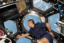 Wakata of the Japan Aerospace Exploration Agency (JAXA) peers at the Earth below from inside the cupola as the International Space Station orbiting 261 miles above the Pacific Ocean off the coast of Peru.