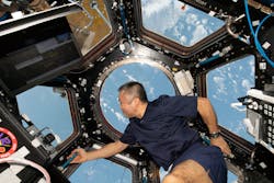 Wakata of the Japan Aerospace Exploration Agency (JAXA) peers at the Earth below from inside the cupola as the International Space Station orbiting 261 miles above the Pacific Ocean off the coast of Peru. Wakata of the Japan Aerospace Exploration Agency (JAXA) peers at the Earth below from inside the cupola as the International Space Station orbiting 261 miles above the Pacific Ocean off the coast of Peru.