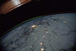 A portion of the International Space Station's solar arrays caps this nighttime view of Earth with aurora as the orbital complex orbited 258 miles above Ukraine and Russia. NASA image. A portion of the International Space Station's solar arrays caps this nighttime view of Earth with aurora as the orbital complex orbited 258 miles above Ukraine and Russia. NASA image.