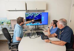 NASA lead software developer, Ethan Williams, left, pilot Scott Howe, and operations test consultant Jan Scofield run a flight path management software simulation at NASA&rsquo;s Armstrong Flight Research Center in Edwards, California. NASA photo.