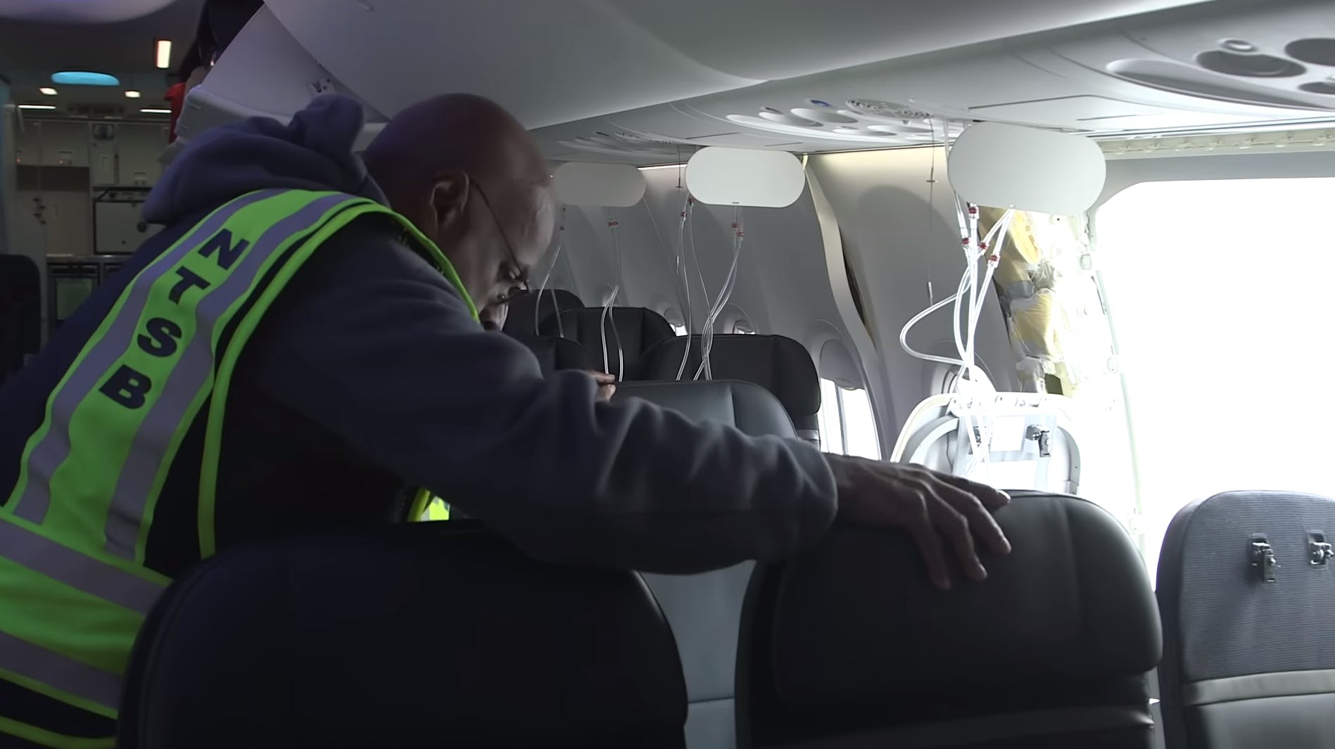 An NTSB inspector looks over the Alaska Airlines Boeing 737 Max 9 aircraft. NTSB image.