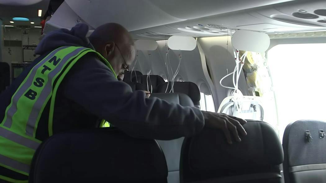 An NTSB inspector looks over the Alaska Airlines Boeing 737 Max 9 aircraft. NTSB image.