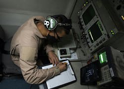 A U.S. Air Force senior airman writes down radar data while flying in an E-3 over Southwest Asia while flying a mission aboard the E-3 Sentry radar reconnaissance aircraft. A U.S. Air Force senior airman writes down radar data while flying in an E-3 over Southwest Asia while flying a mission aboard the E-3 Sentry radar reconnaissance aircraft.