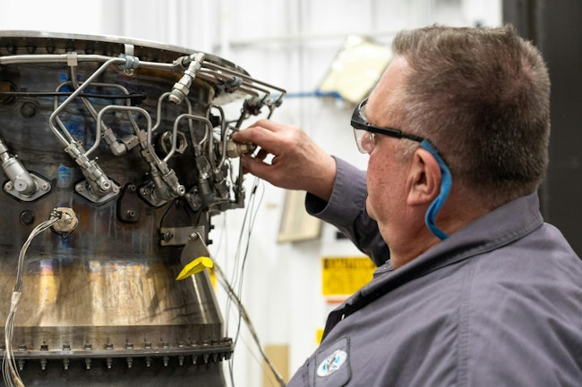 A Pratt & Whitney engineer inspects a full annular combustor rig at the company’s test facility in Middletown, Conn.