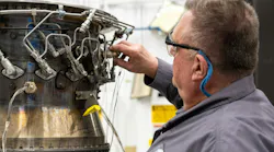 A Pratt & Whitney engineer inspects a full annular combustor rig at the company’s test facility in Middletown, Conn.