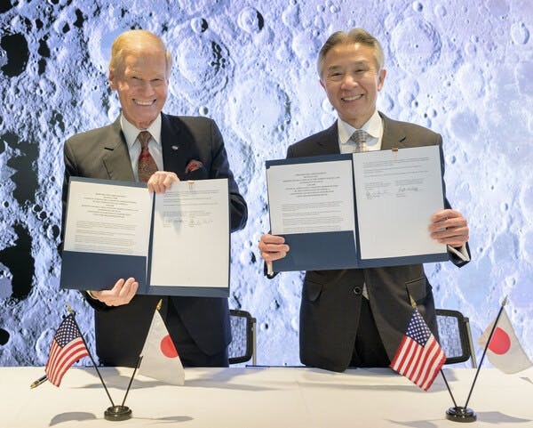 NASA Administrator Bill Nelson, left, and Japan’s Minister of Education, Culture, Sports, Science and Technology Masahito Moriyama, hold signed copies of an historic agreement between the United States and Japan to advance sustainable human exploration of the Moon, Tuesday, 9 April 2024, at the NASA Headquarters Mary W. Jackson Building in Washington. Under the agreement, Japan will design, develop, and operate a pressurized rover for crewed and uncrewed exploration on the Moon. NASA will provide the launch and delivery of the rover to the Moon as well as two Japanese astronaut missions to the lunar surface. Photo Credit: (NASA/Bill Ingalls)
