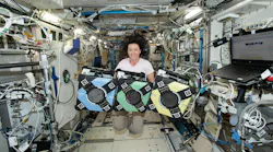 NASA astronaut Megan McArthur with the Astrobee robotic free-flyers. NASA photo.