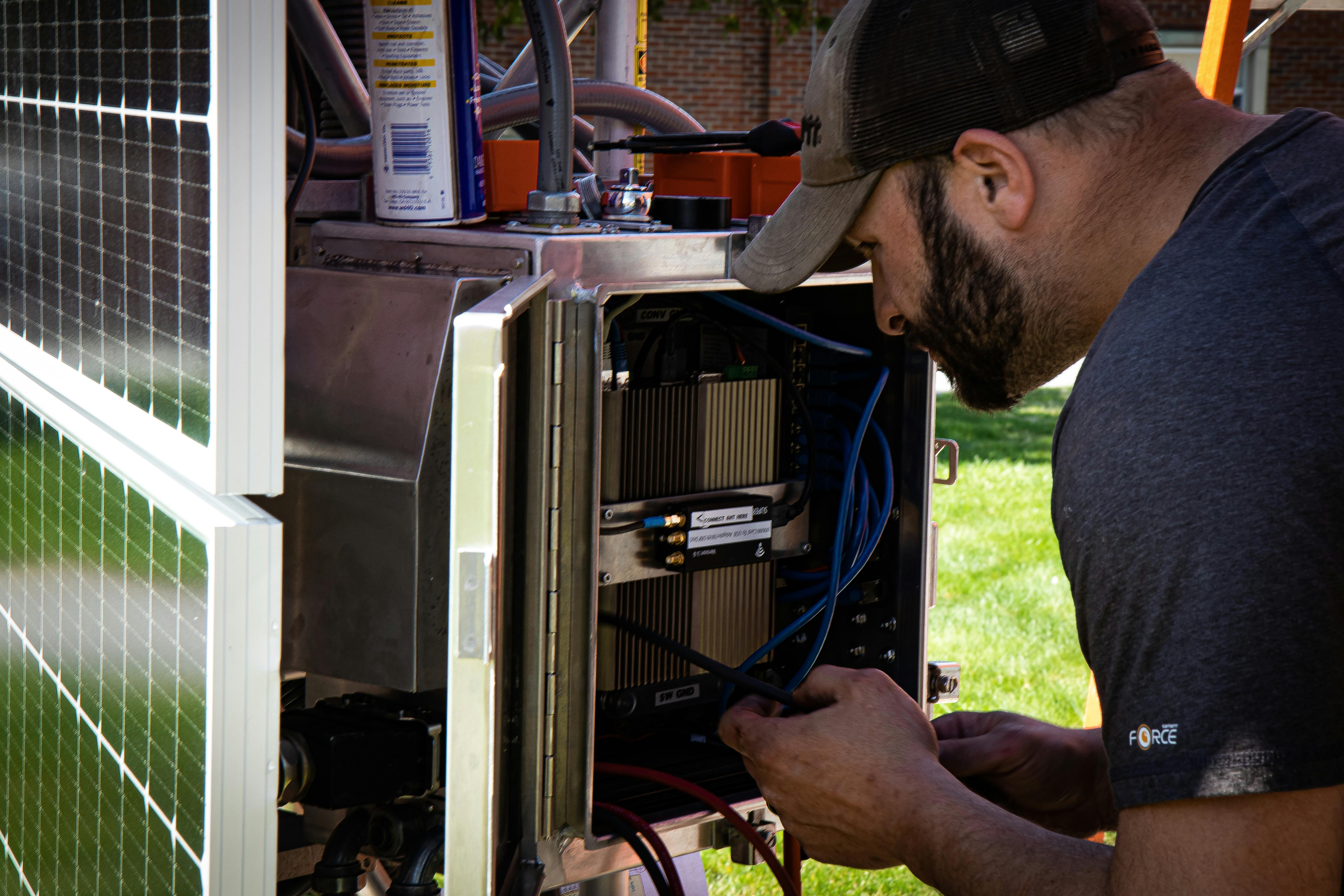 Technicians assemble a newly engineered automated terrestrial laser scanning system (A-TLS) on a 12-foot-tall tower affixed with multiple lidar laser scanners, meteorological sensors, and solar panels to map where components go prior to the tower being disassembled and shipped to Alaska.