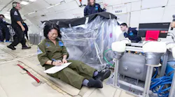 QuynhGiao Nguyen takes experiment notes while Pierre-Lucas Aubin-Fournier and George Butt oversee experiment operations during a soil reset period between parabolas. NASA photo.