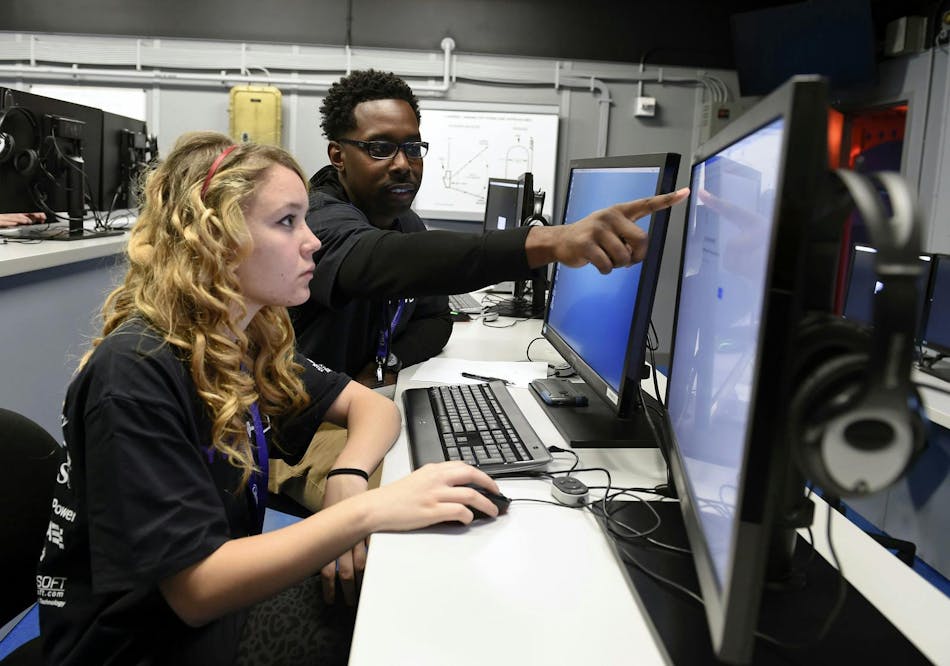 A U.S. military network cryptologic technician helps a high school student complete cyber security challenges. Navy photo A U.S. military network cryptologic technician helps a high school student complete cyber security challenges. Navy photo