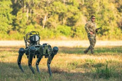 An Air Force technician observes Atom the artificially intelligent robotic dog as teammates operate it via remote control training at Barksdale Air Force Base, La., last fall. Air Force photo An Air Force technician observes Atom the artificially intelligent robotic dog as teammates operate it via remote control training at Barksdale Air Force Base, La., last fall. Air Force photo