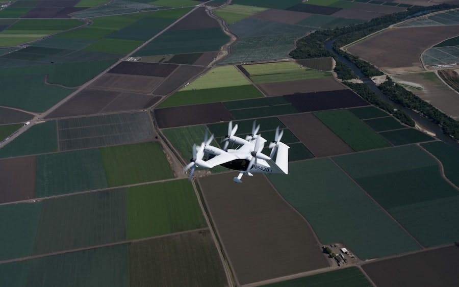 Joby&rsquo;s all-electric aircraft in flight above Marina, California, the company&rsquo;s manufacturing and flight test center. Joby Aviation photo.