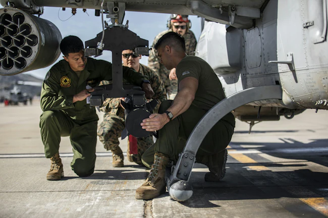 U.S. Marines with Marine Light Attack Helicopter Squadron 267 load a joint air-to-ground missile (JAGM) onto an AH-1Z Viper attack helicopter.