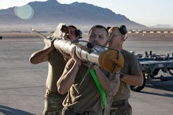 An Aim 9x Infrared Guided Air To Air Missile Is Loaded Onto A Us Military Combat Aircraft An Aim 9x Infrared Guided Air To Air Missile Is Loaded Onto A Us Military Combat Aircraft