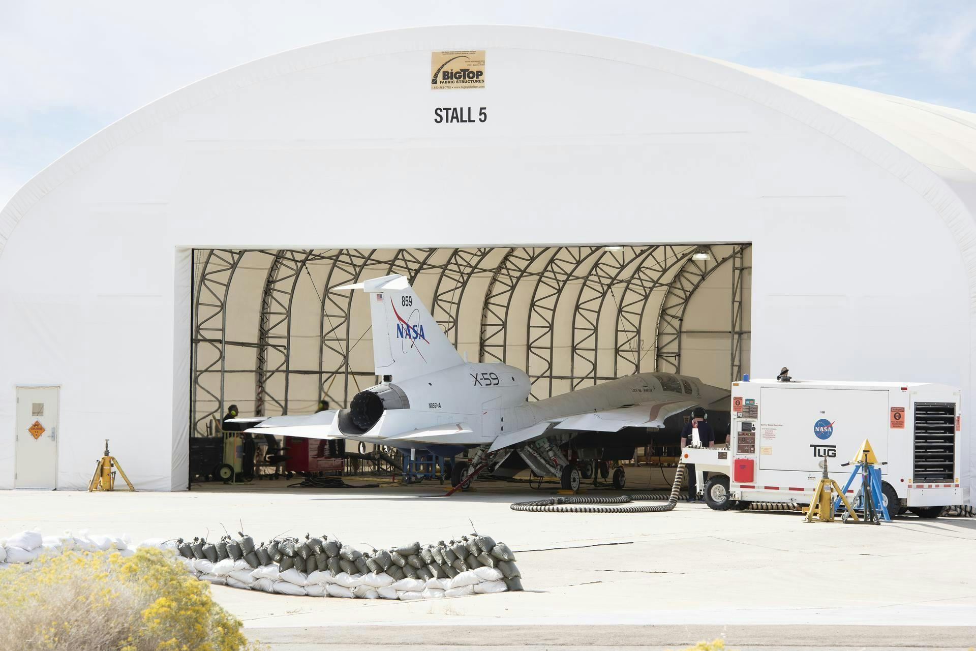 NASA&rsquo;s X-59 quiet supersonic research aircraft sits in its run stall at Lockheed Martin&rsquo;s Skunk Works facility in Palmdale, California, firing up its engine for the first time. These engine-run tests start at low power and allow the X-59 team to verify the aircraft&rsquo;s systems are working together while powered by its own engine. The X-59 is the centerpiece of NASA&rsquo;s Quesst mission, which seeks to solve one of the major barriers to supersonic flight over land by making sonic booms quieter. NASA/Carla Thomas image.