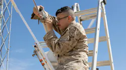A U.S. Marine Corps transmission systems operator installs a 5G antenna for a demonstrat at the Marine Corps Air Ground Combat Center at Twentynine Palms, Calif. U.S. Marine Corps photo by Pfc. Ryan Kennelly