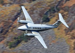 A King Air twin prop plane banks while in flight. A King Air twin prop plane banks while in flight.