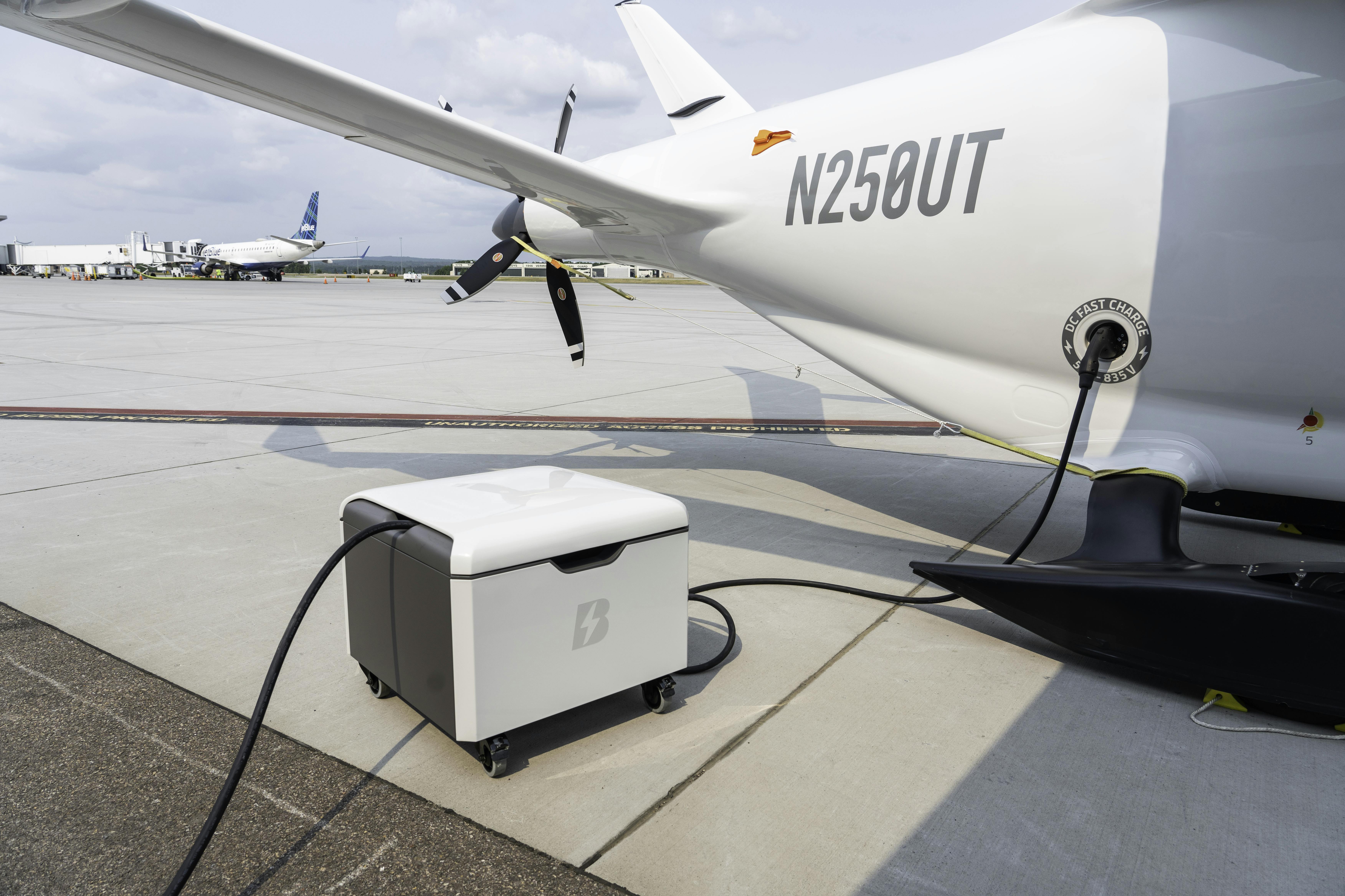 A Beta Technologies power cube plugged into an airplane.