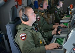 An electronic warfare operator monitors his workstation on a P-8A Poseidon maritime surveillance jet during a mission to assist in search and rescue efforts. An electronic warfare operator monitors his workstation on a P-8A Poseidon maritime surveillance jet during a mission to assist in search and rescue efforts.