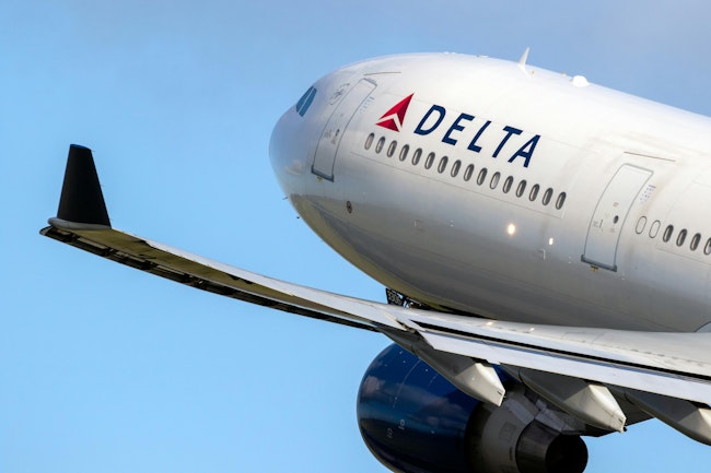 A Delta-branded Airbus commercial jet takes off.