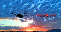 A quadcopter flies as the sun rises in the distance with the Red Cat logo off to the side. A quadcopter flies as the sun rises in the distance with the Red Cat logo off to the side.