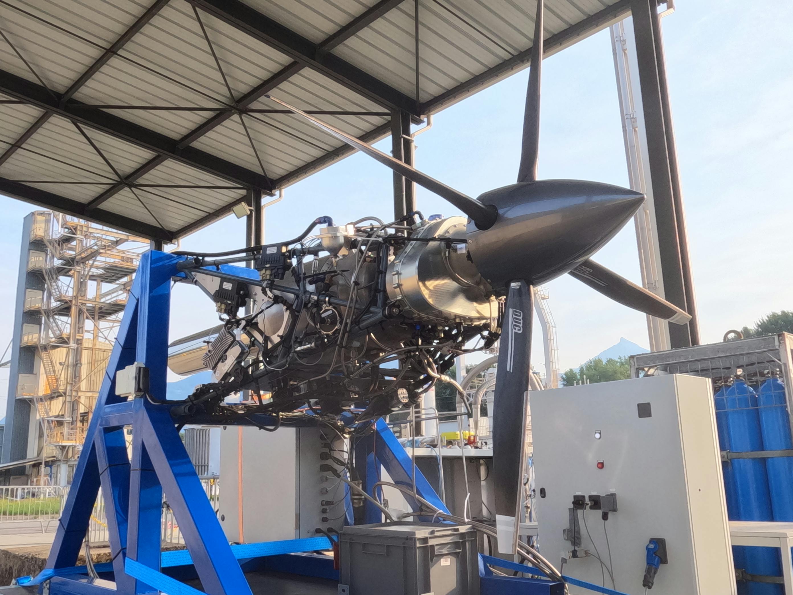 A photo of an unshrouded propeller aircraft engine on a stand.