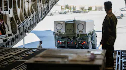U.S. Marines back a Navy/Marine Corps Expeditionary Ship Interdiction System (NMESIS) launcher onto a C-17 cargo jet for transport at Travis Air Force Base, Calif.