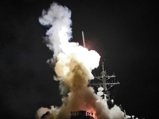 A Tomahawk missile launches from the Arleigh Burke-class guided-missile destroyer USS Barry